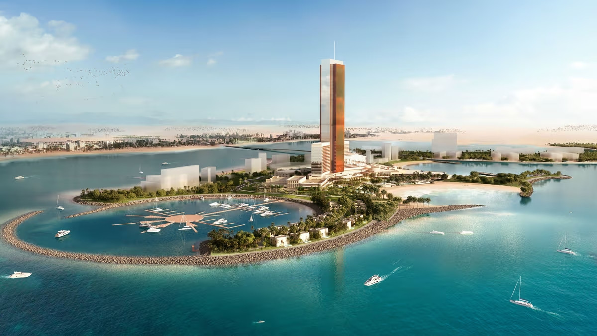 Vue aérienne d’un complexe architectural moderne sur une île artificielle entourée d’eau turquoise, avec une tour élancée et des palmiers.